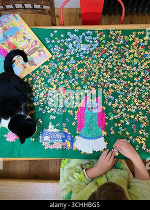 Child doing a jigsaw puzzle Stock Photo