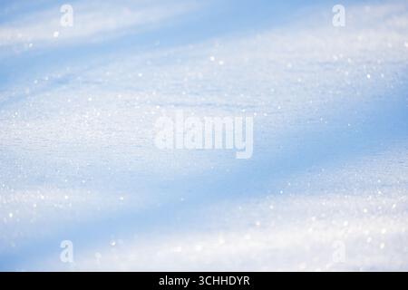Glittering snowflakes shining under sunlight, evoking feelings of peace and winter serenity. Natural background photography with selective soft focus Stock Photo