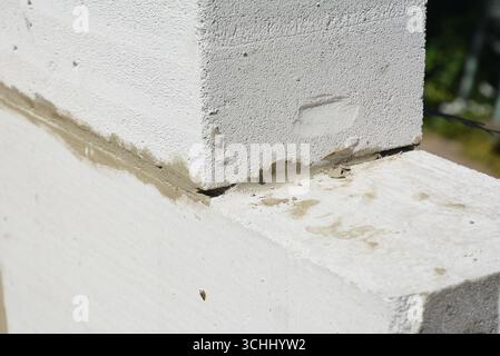 Laying autoclaved aerated concrete blocks for house wall. Close up on laying blocks Stock Photo