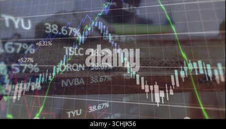 Displaying digital trading chart with candlesticks and trend lines in office with ticker symbols Stock Photo
