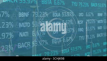 Displaying HUD highlighting stock data on wind farm with turbines, ticker and percentage overlays Stock Photo