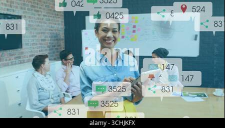 Leading discussion woman wearing blouse and skirt holding tablet in meeting room, with whiteboard Stock Photo