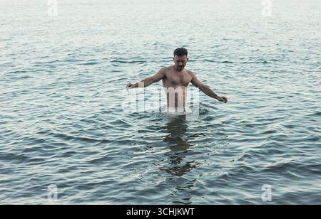 Portrait of a happy guy swimming in the sea Stock Photo