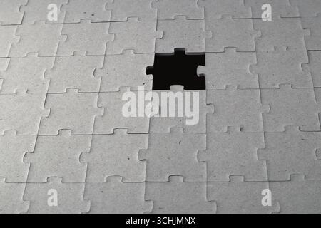A black hole in the puzzle. Concept of deep thinking or astronomy. Stock Photo