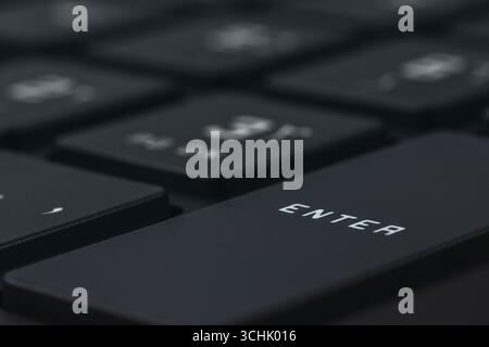Close-up and full view of a modern computer keyboard, enter key Stock Photo
