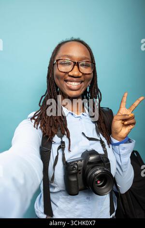 Woman wearing suspenders and camera around neck outdoors Stock Photo ...