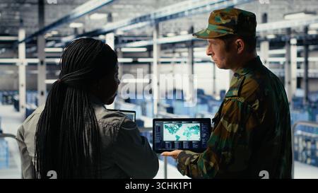 African American commander in camouflage speaking and pointing at ...