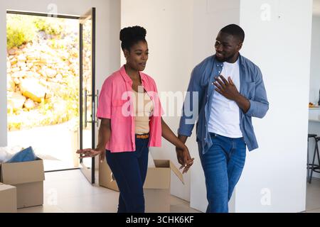 Couple unpacking boxes in new home, smiling and enjoying moment together Stock Photo