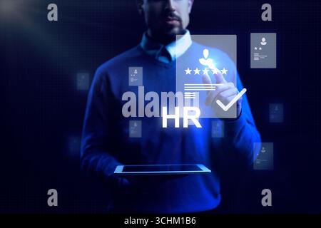 Human resources professional uses digital tools for employee evaluation and management in a modern workspace Stock Photo