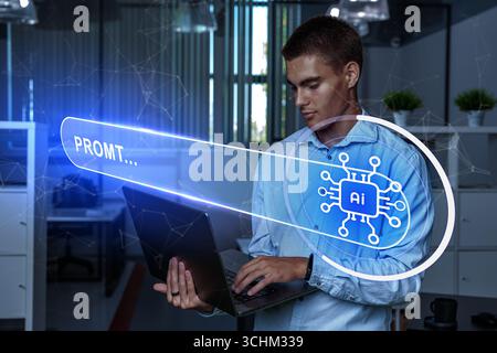Young man using a laptop in a modern office while interacting with artificial intelligence technology display Stock Photo