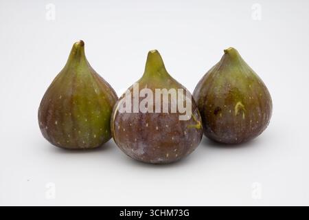 Three ripe figs on a white background. Stock Photo