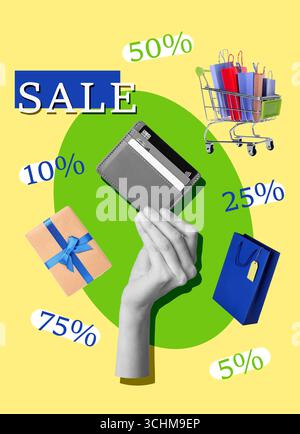 Female hand with wallet, gift, shopping cart and bags on yellow background Stock Photo