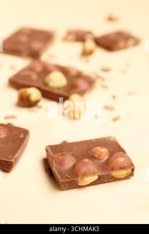 Sweet tasty chocolate with nuts on  beige background Stock Photo