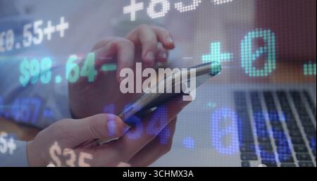 Tapping business person's hands interacting with smartphone on desk, with financial data overlay Stock Photo