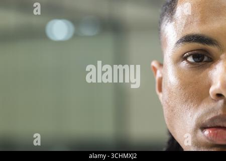 African american man leaning against wall panel while soft light reflecting, copy space Stock Photo