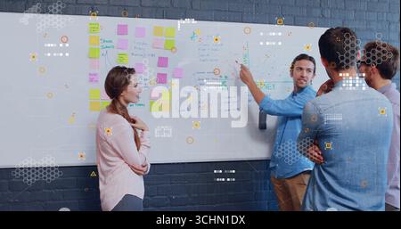 Pointing man in light blue shirt explaining flowchart on whiteboard in meeting room, copy space Stock Photo