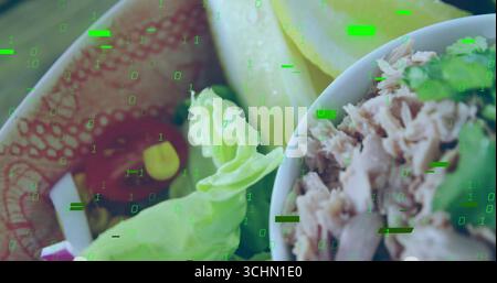Displaying bowl holding lettuce, endive, corn, tuna with herbs on wooden table, with binary overlay Stock Photo
