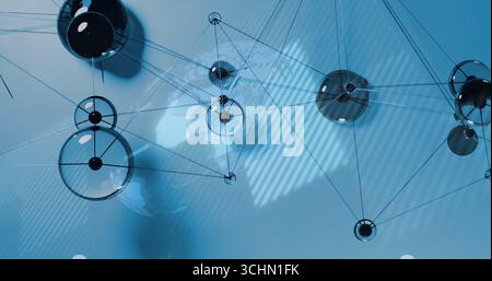 Displaying glass sphere network forming web in blue background, with metallic nodes, rods and wires Stock Photo