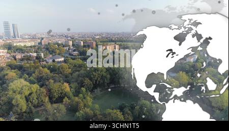 Displaying halftone world map overlaying aerial park view, with trees and skyscrapers, copy space Stock Photo