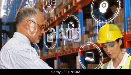 Reviewing inventory supervisor, engineer using tablet at warehouse center with racks, digital icons Stock Photo