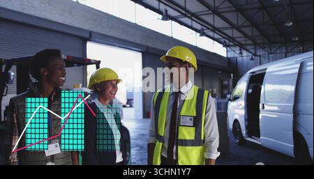 Discussing loading tasks warehouse workers wearing helmets and vests in loading bay, with forklift Stock Photo