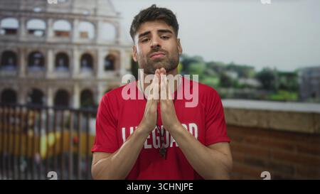 Man lifeguard raises hands with whistle in front of the ancient roman colosseum building; helpless frustration. Stock Photo