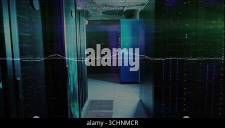 Glowing server cabinets lining narrow data center corridor, with LED indicators and cable trays Stock Photo