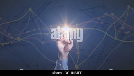 Touching hand in blue shirt reaching toward glowing node in virtual interface, with network overlay Stock Photo
