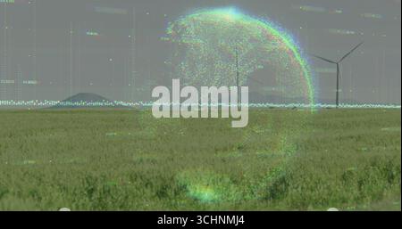 Holographic glitch sphere hovering above grassland plain, with three wind turbines and digital code Stock Photo