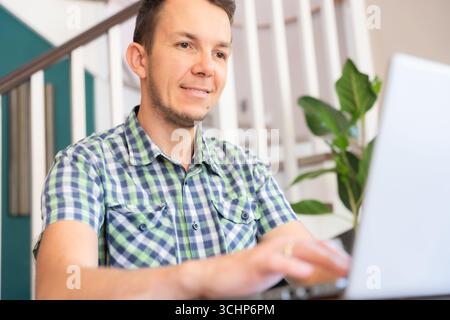 Smiling Man Using Laptop At Home Office Positive Remote Work Concept Stock Photo