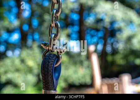Swing Chain Connector With Rope, Metal Hardware Safety Detail On Outdoor Playground Stock Photo