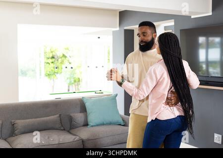 African American couple dancing together at home, enjoying joyful moment Stock Photo