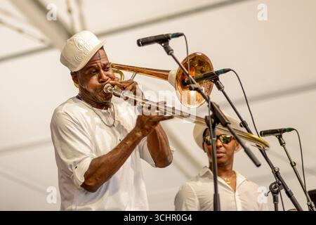 NEW ORLEANS, LA, USA - MAY 2, 2019: Second Trombone in Glen David Andrews band performs a solo as his bandmate looks on at the New Orleans Jazz and Heritage Festival Stock Photo
