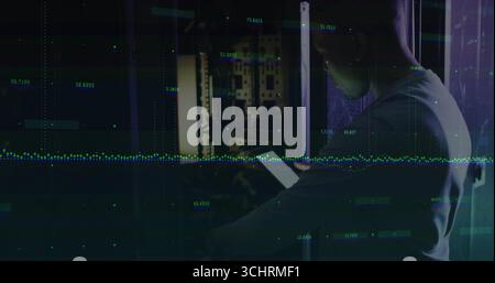 Inspecting IT technician scanning server rack in server room with tablet, waveform, copy space Stock Photo