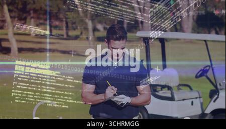 Golfer holding pencil and writing on notepad at fairway, in polo shirt with cart, code overlays Stock Photo