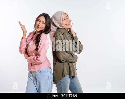 Two friends are posing playfully together in their stylish and casual attire Stock Photo