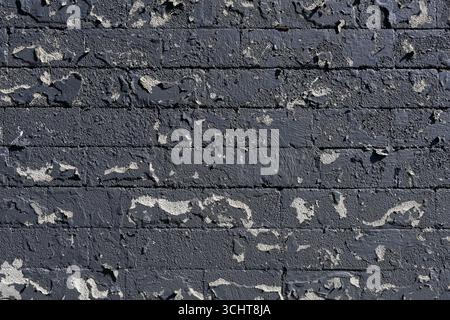 Peeling paint on a old brick wall for use as a background texture Stock Photo