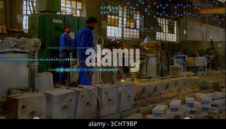 Operating gas torch worker in coveralls heating concrete molds in shop, with control panel Stock Photo