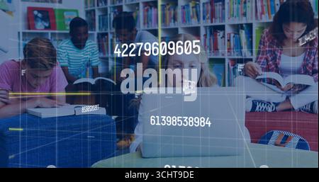 Studying group of five students typing and reading in library area, with laptop and open books Stock Photo