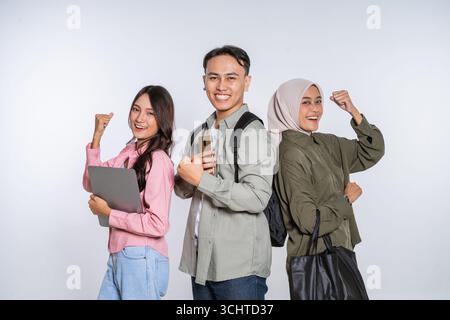 A Diverse Group of Young Adults Joyfully Celebrating Their Academic Success Together Stock Photo