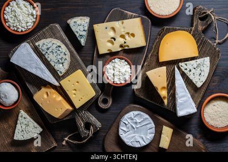 Set of different cheeses on wooden cutting boards, close up, top view . Various types of cheese Stock Photo