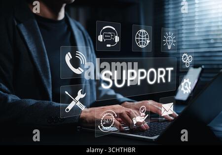 Technical Support and Customer Service Concept. Person using laptop with icons for phone, chat, email, tools, and 24/7 service, representing technical Stock Photo