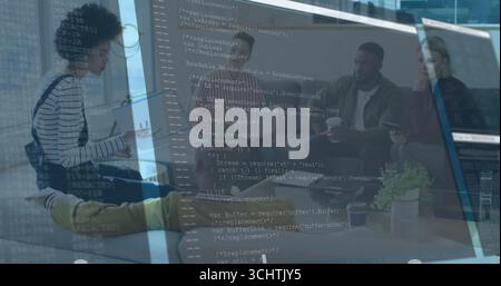 Five tech professionals discussing ideas in office lounge, with cups on table and code reflection Stock Photo