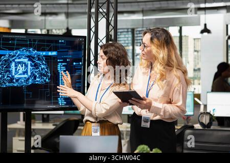 Team of coworkers using strategic artificial intelligence cloud computing to conduct data analysis, optimized decision making and project forecasting. Development with AI automation. Stock Photo