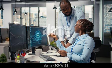 Prop firm staff members using artificial intelligence tech to ensure smooth trading operations. Team of traders in office using AI chatbot to analyze stock market portfolio positions Stock Photo
