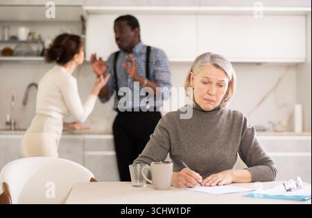 Couple discussing testament with elderly woman Stock Photo