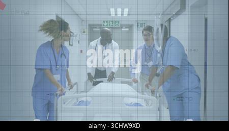 Walking medical team wearing scrubs and lab coat pushing gurney in hospital corridor with exit sign Stock Photo