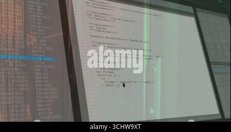 Displaying dual monitors showing JavaScript code editor windows on office desk, with thin bezels Stock Photo