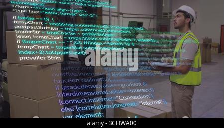 Scanning boxes on tablet in warehouse with code overlay, wearing safety vest, hard hat, copy space Stock Photo