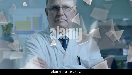 Standing scientist wearing lab coat crossing arms in lab, with periodic table and digital overlay Stock Photo